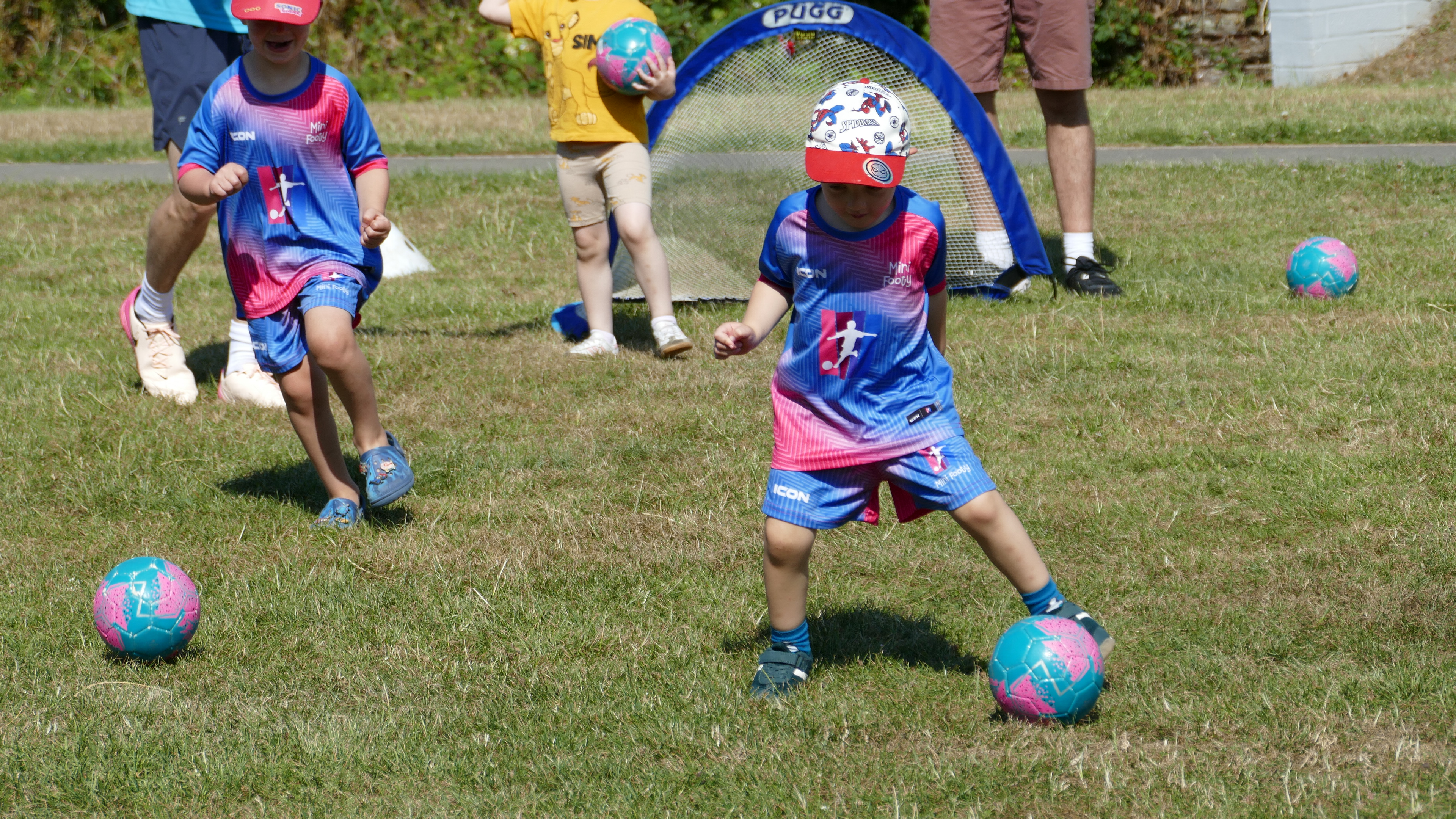 Children enjoying a colourful football activity during a Mini Footy class
